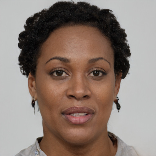 Joyful black adult female with short  brown hair and brown eyes