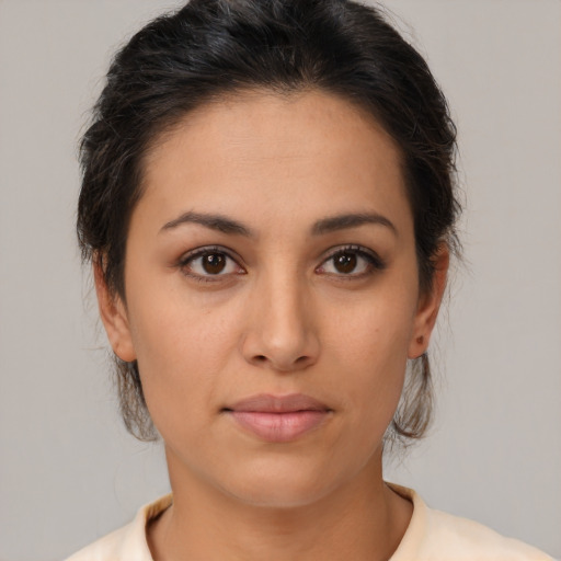 Joyful latino young-adult female with medium  brown hair and brown eyes