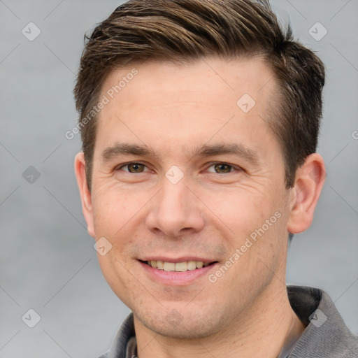 Joyful white adult male with short  brown hair and grey eyes