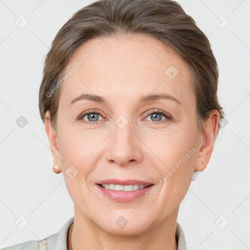 Joyful white adult female with short  brown hair and grey eyes