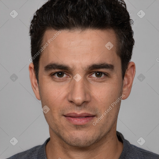 Joyful white young-adult male with short  black hair and brown eyes