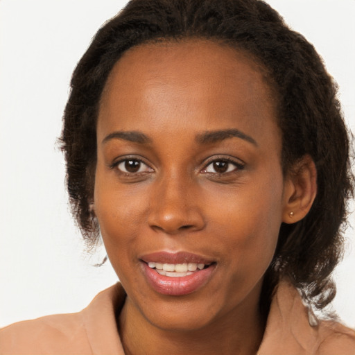 Joyful black young-adult female with long  brown hair and brown eyes