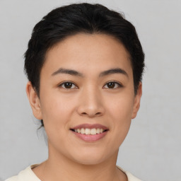 Joyful asian young-adult female with short  brown hair and brown eyes