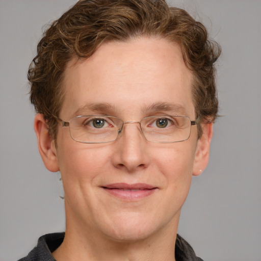 Joyful white adult male with short  brown hair and blue eyes