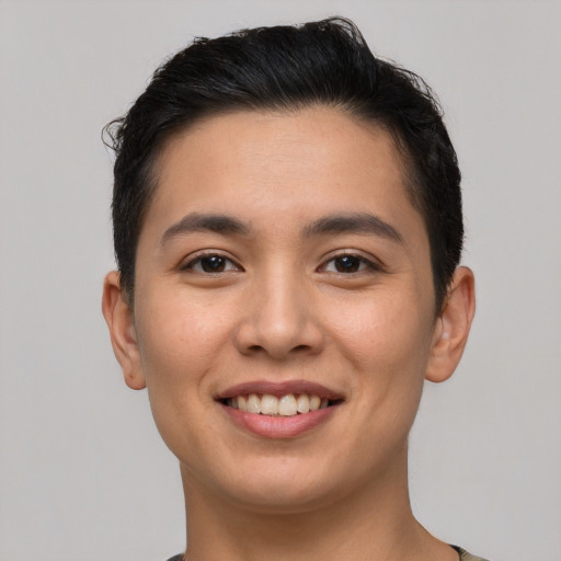 Joyful latino young-adult male with short  brown hair and brown eyes