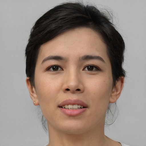 Joyful asian young-adult female with short  brown hair and brown eyes