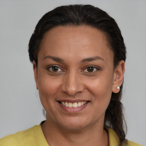 Joyful latino young-adult female with short  brown hair and brown eyes