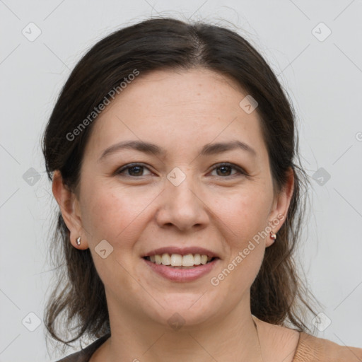 Joyful white adult female with medium  brown hair and brown eyes