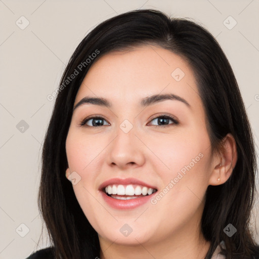 Joyful white young-adult female with long  black hair and brown eyes