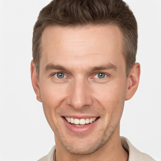 Joyful white adult male with short  brown hair and grey eyes