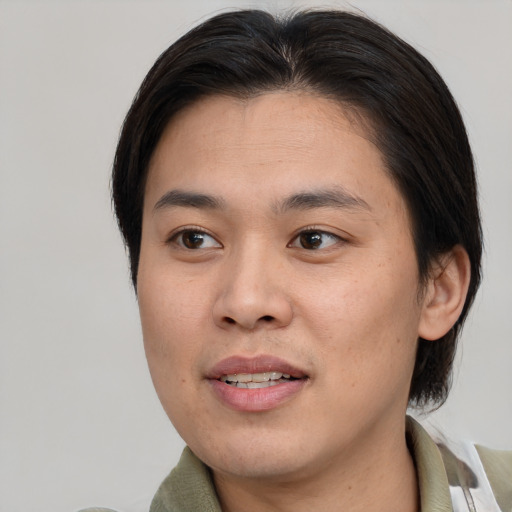 Joyful asian young-adult male with medium  brown hair and brown eyes