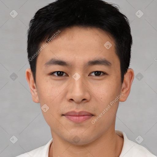 Joyful asian young-adult male with short  black hair and brown eyes