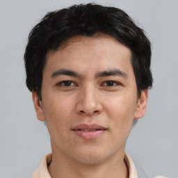 Joyful asian young-adult male with short  brown hair and brown eyes