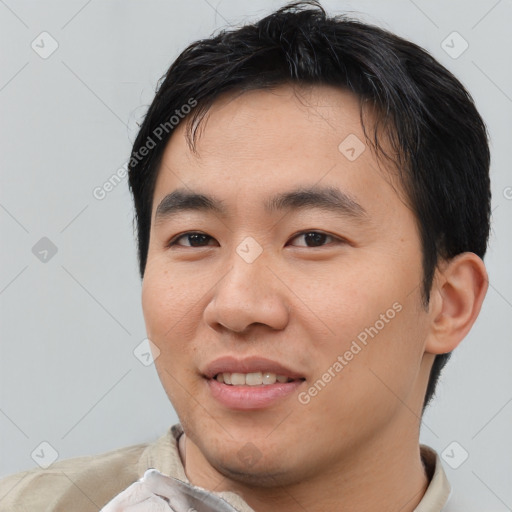 Joyful asian young-adult male with short  black hair and brown eyes