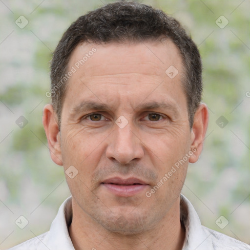 Joyful white adult male with short  brown hair and brown eyes