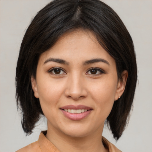 Joyful asian young-adult female with medium  brown hair and brown eyes