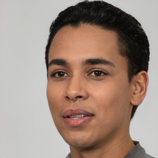 Joyful latino young-adult male with short  black hair and brown eyes