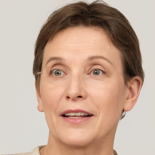 Joyful white adult female with short  brown hair and grey eyes