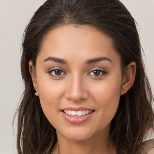 Joyful white young-adult female with long  brown hair and brown eyes