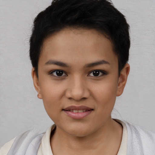 Joyful latino young-adult female with short  black hair and brown eyes