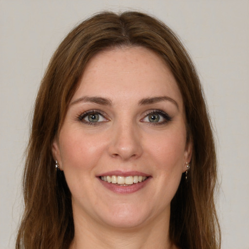 Joyful white young-adult female with long  brown hair and green eyes