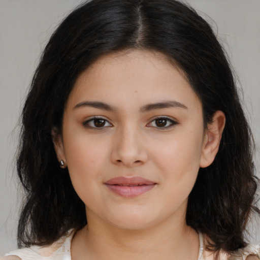 Joyful latino young-adult female with long  brown hair and brown eyes