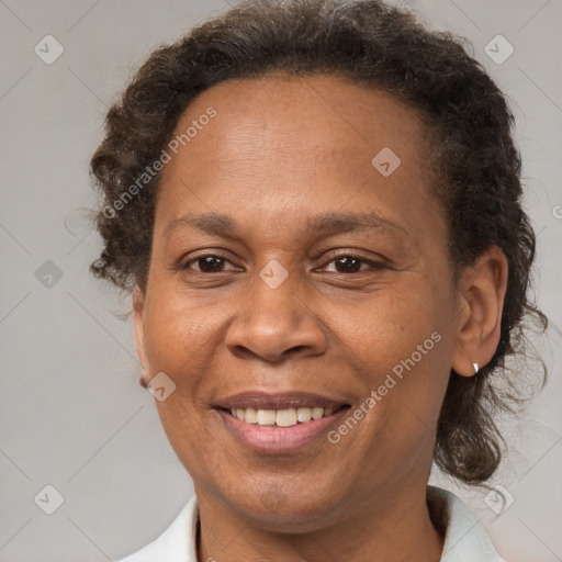 Joyful black adult female with short  brown hair and brown eyes