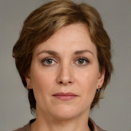 Joyful white adult female with medium  brown hair and grey eyes