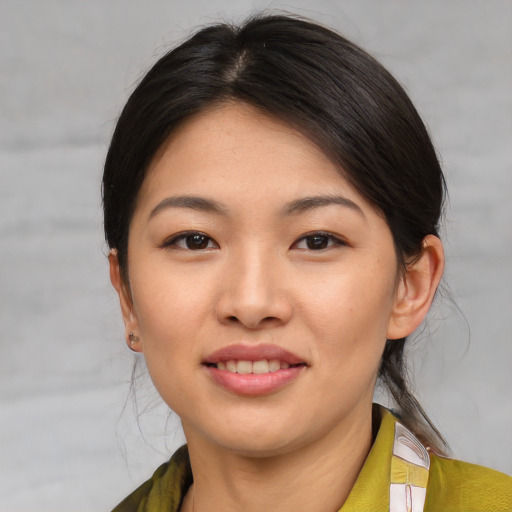 Joyful asian young-adult female with medium  brown hair and brown eyes