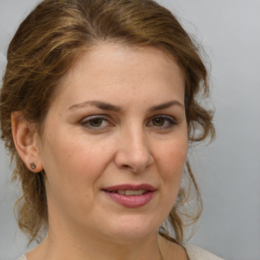 Joyful white adult female with medium  brown hair and brown eyes