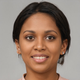 Joyful latino young-adult female with medium  brown hair and brown eyes