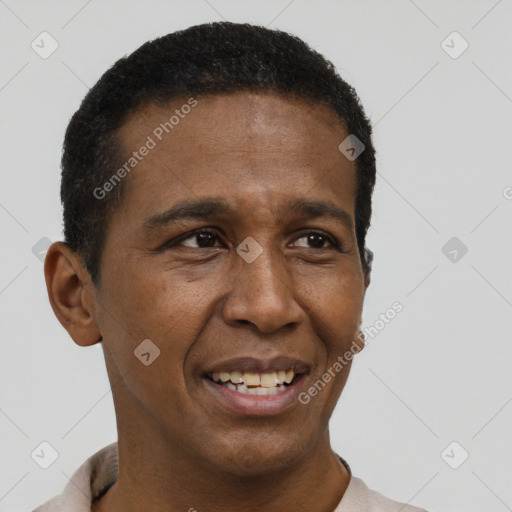 Joyful black young-adult male with short  black hair and brown eyes