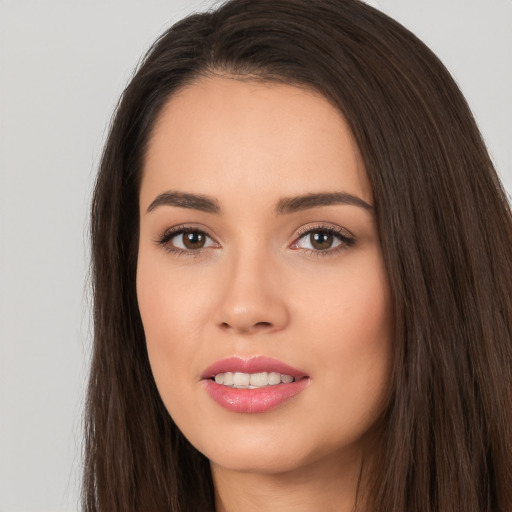 Joyful white young-adult female with long  brown hair and brown eyes