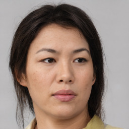 Neutral asian adult female with medium  brown hair and brown eyes