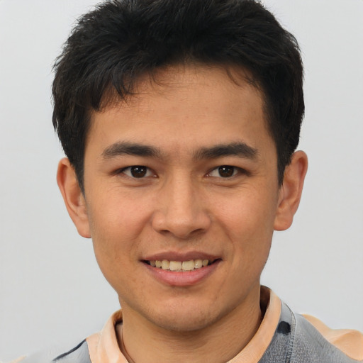 Joyful latino young-adult male with short  brown hair and brown eyes