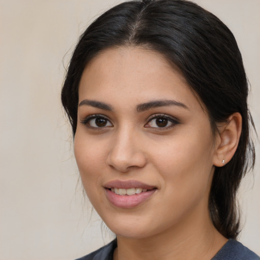 Joyful latino young-adult female with medium  brown hair and brown eyes