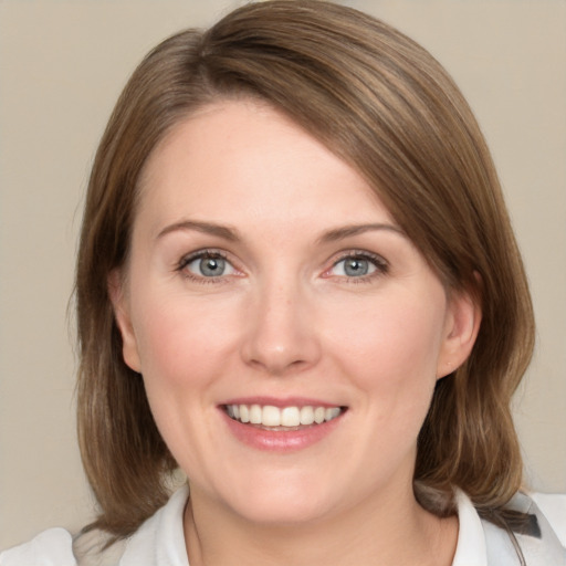 Joyful white young-adult female with medium  brown hair and green eyes