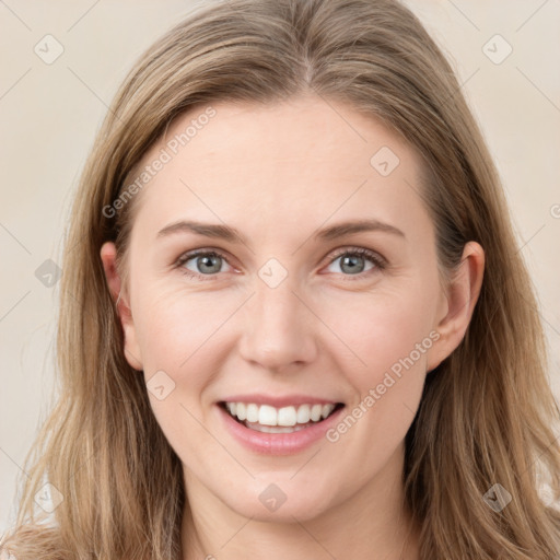 Joyful white young-adult female with long  brown hair and blue eyes