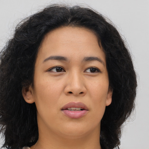 Joyful asian young-adult female with long  brown hair and brown eyes