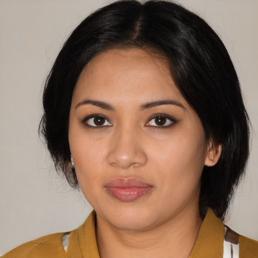 Joyful latino young-adult female with medium  black hair and brown eyes