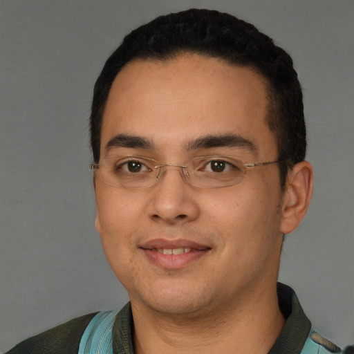 Joyful latino young-adult male with short  black hair and brown eyes