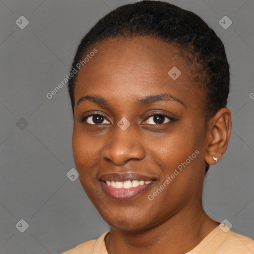 Joyful black young-adult female with short  black hair and brown eyes