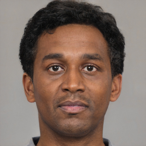 Neutral black young-adult male with short  brown hair and brown eyes