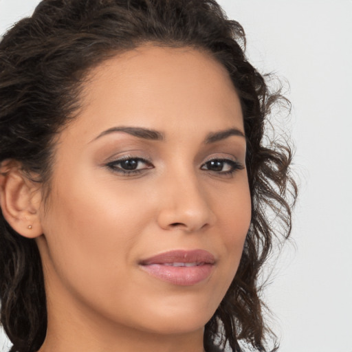 Joyful latino young-adult female with long  brown hair and brown eyes