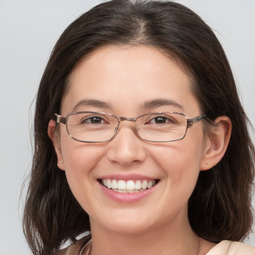 Joyful white adult female with medium  brown hair and grey eyes