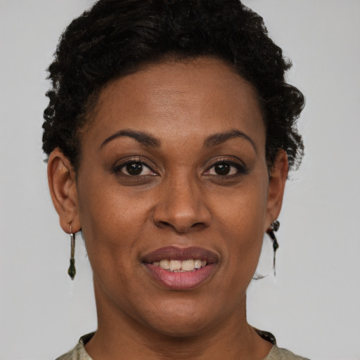 Joyful black adult female with short  brown hair and brown eyes