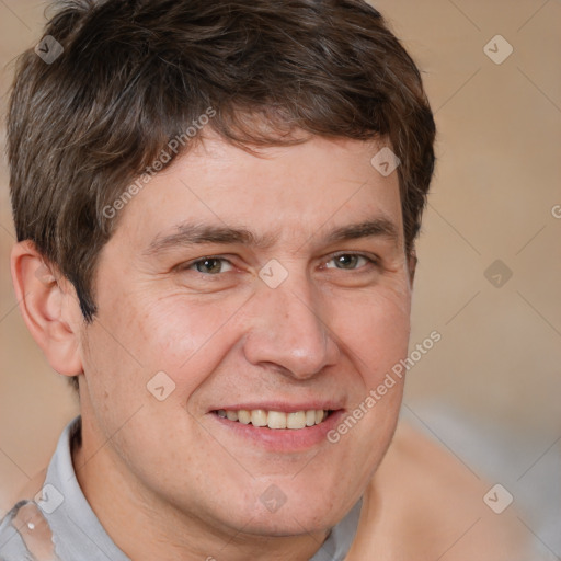 Joyful white adult male with short  brown hair and brown eyes