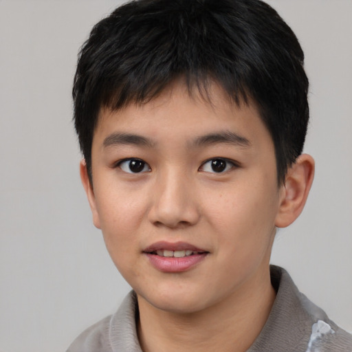 Joyful asian child male with short  black hair and brown eyes