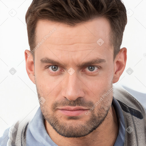 Joyful white young-adult male with short  brown hair and grey eyes