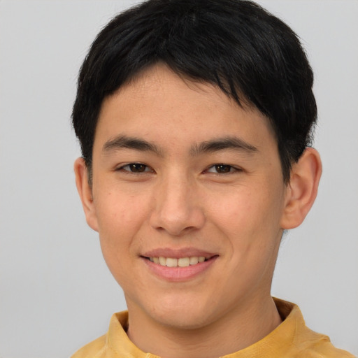 Joyful asian young-adult male with short  brown hair and brown eyes